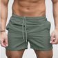 Khaki lightweight beach shorts on model showing split side hem detail