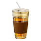 Glass straw cup filled with cold brew on a sunlit desk