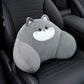 Gray cat lumbar support pillow with a white muzzle resting on a black car seat