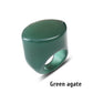 Green agate stone ring with a domed face on a white background