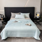 Summer coverlet draped across a chair back, contrast piping tracing the outer edge