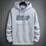 Light gray fleece-lined hooded sweatshirt on a hanger with a NEVER GIVE UP print and a front pocket