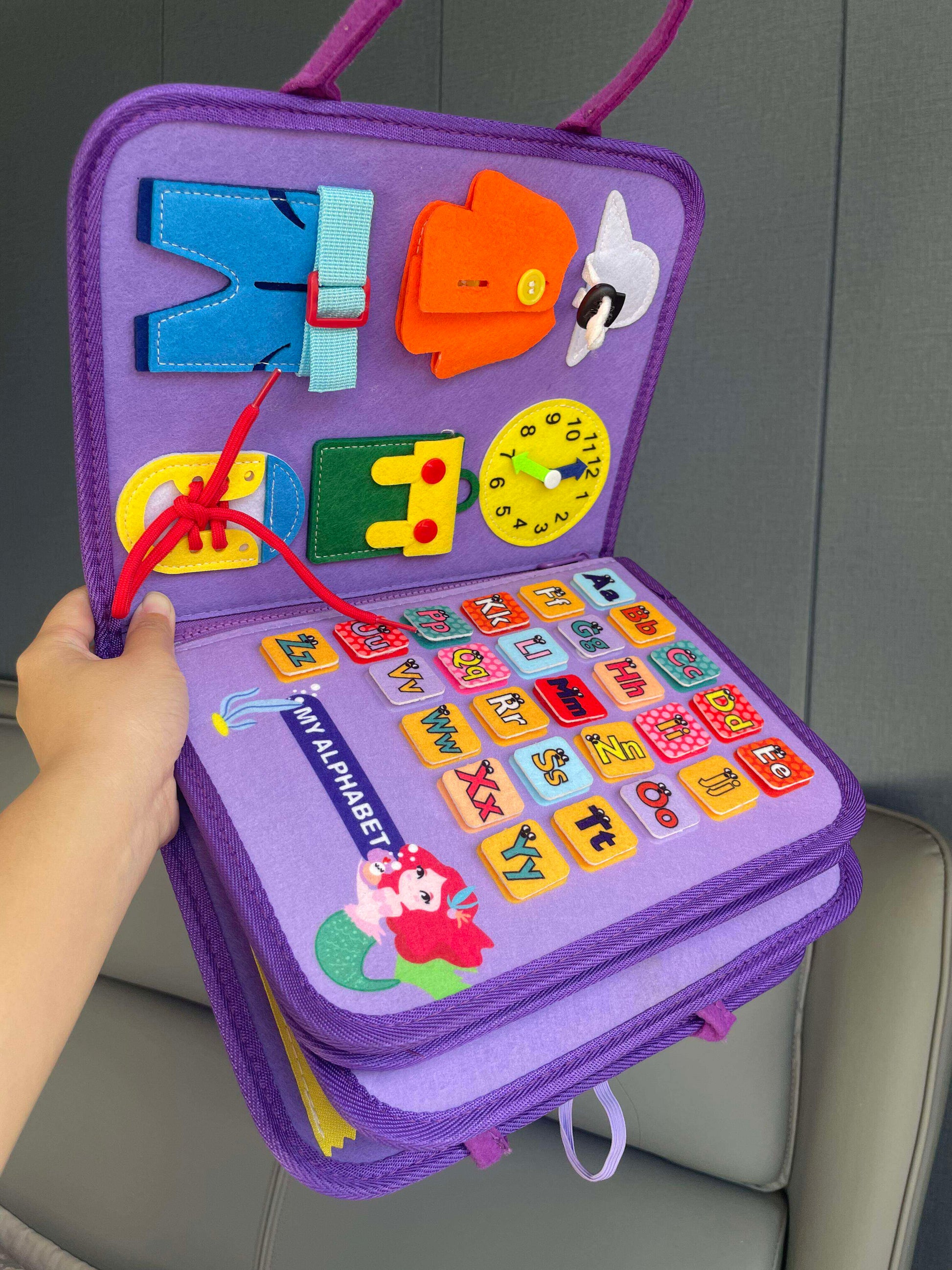 Cloth activity book styled on a nursery play mat