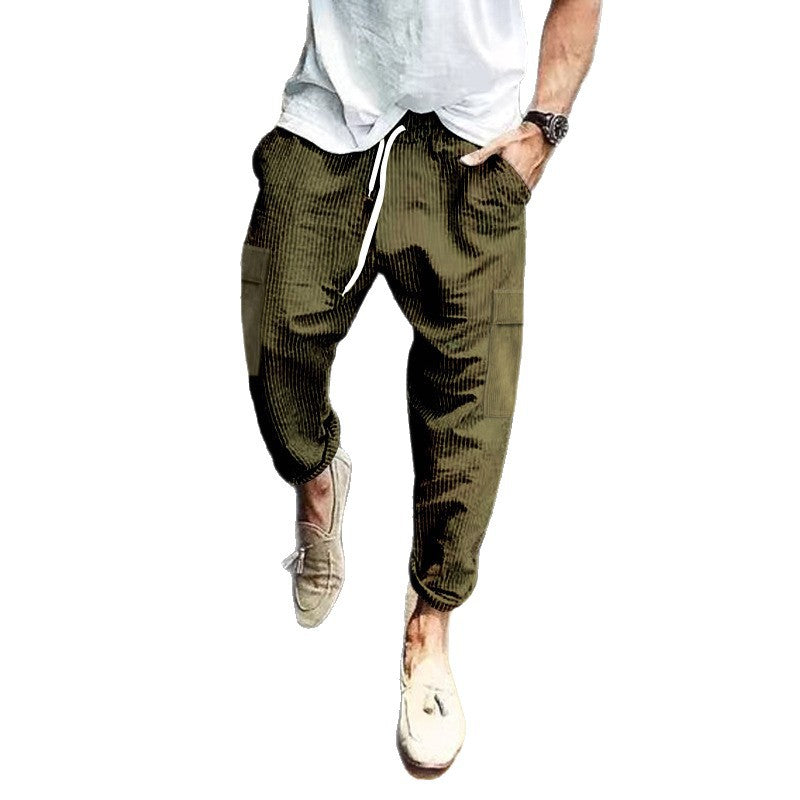 Army green ribbed corduroy pants with white drawstring and thigh patch pockets on a white background