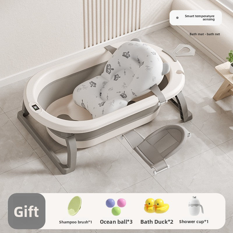 Baby bathtub with printed floating mat and a gray bath net lying beside it on the floor