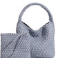 Front view of grey plaited PU leather bucket bag showing the basket weave lattice and open top