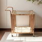 Front view of the gold serving cart showing two glass shelves and slim upright side bars