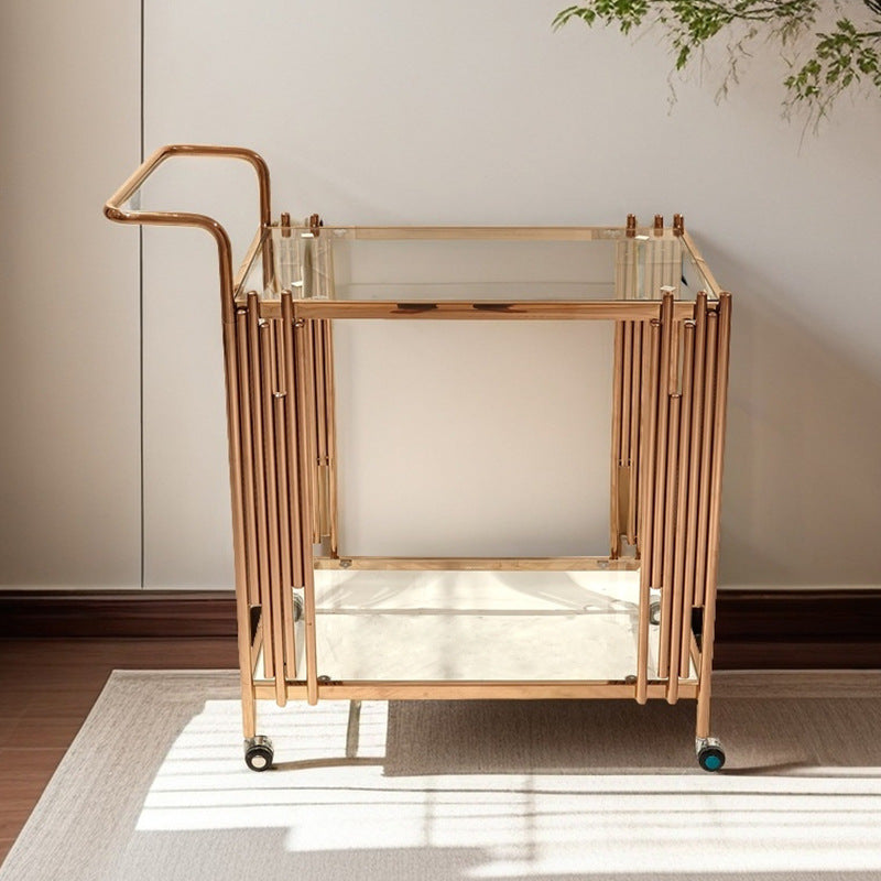Front view of the gold serving cart showing two glass shelves and slim upright side bars