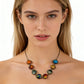 Woman wearing the antique bronze tone solar system necklace, eight cabochons sitting along the collarbone