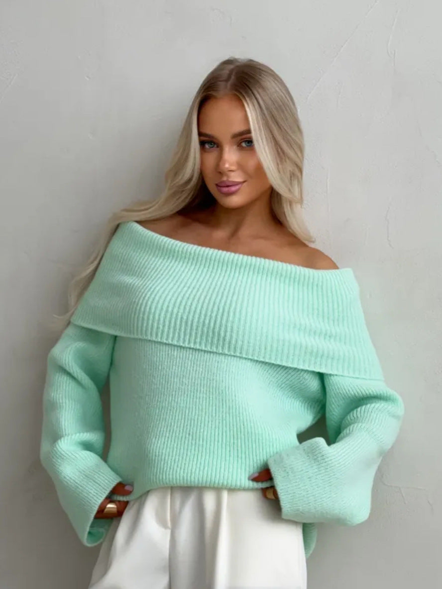 Mint green off-shoulder fold-over knit sweater with wide cuffs worn with white trousers