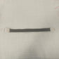 Single grey toned elastic quick release tourniquet band with a white snap buckle laid flat