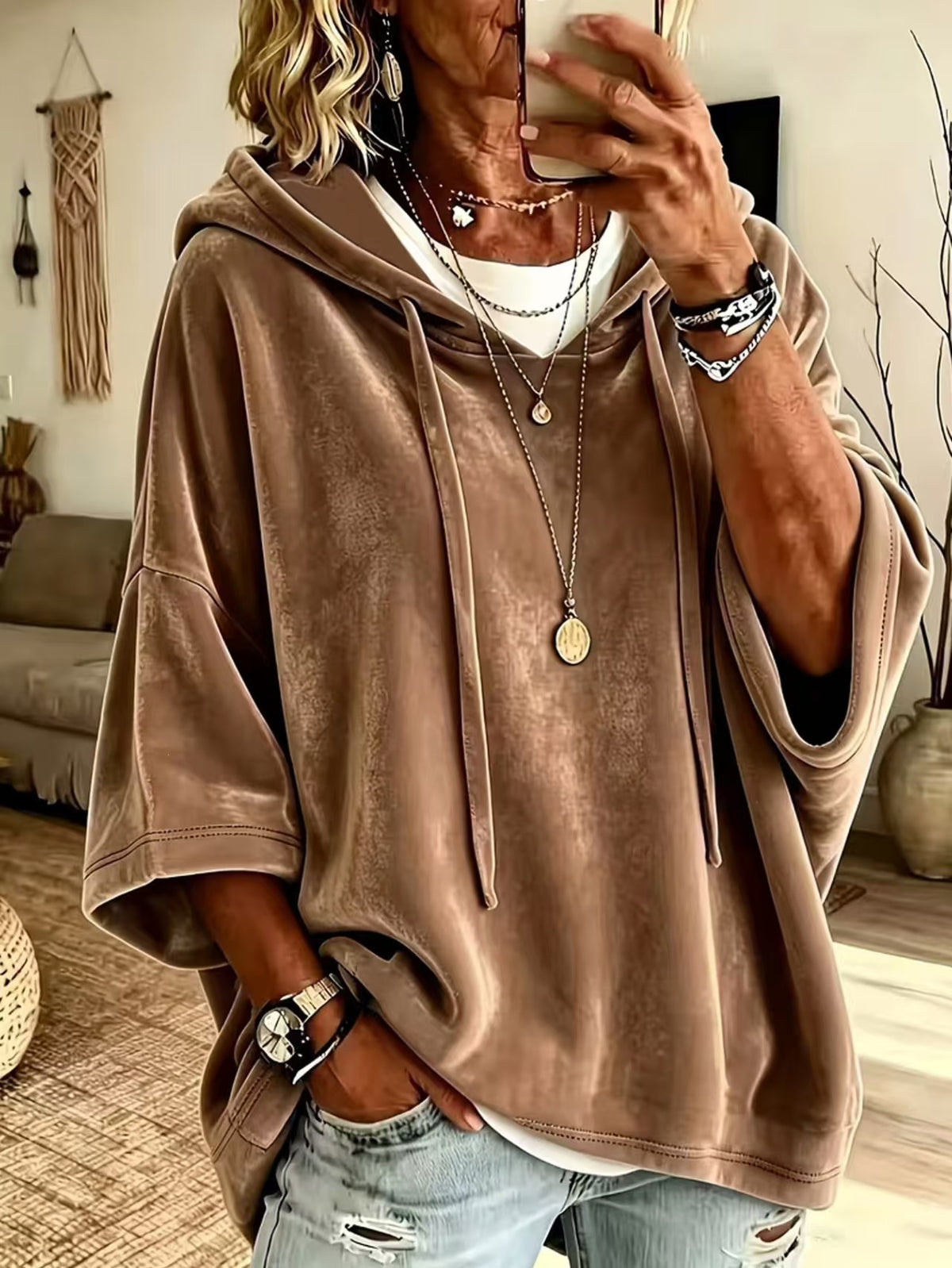 Womens loose hooded top with a dropped shoulder line and mid length hem