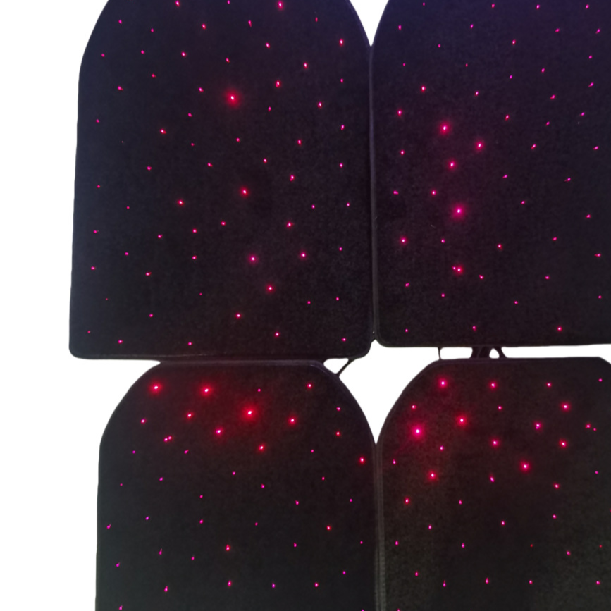 Four black car floor mats glowing with red and pink star-like points of light on a dark background