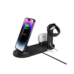 Black four in one charging stand holding a phone, a smartwatch and wireless earbuds