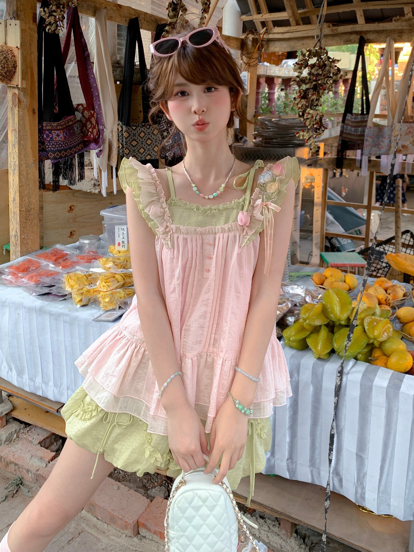 Side view of the sleeveless floral top showing open armhole and Peach Pink print