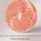 Sakura pink silicone scalp brush with soft swirling bristles and a palm grip