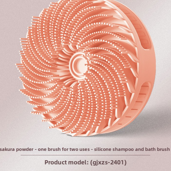 Sakura pink silicone scalp brush with soft swirling bristles and a palm grip