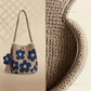Blue floral crochet cotton bucket bag on a strap beside a close up of the cotton weave