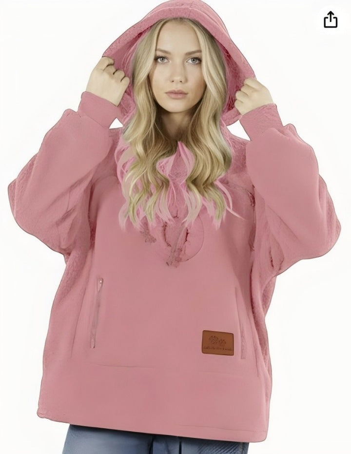 Pink sherpa fleece pet pouch hoodie on a woman with the hood pulled up