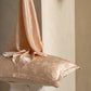 Peach Floral jacquard silk pillowcase with silk draped over it, pair option