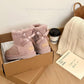 Pink suede ankle boots with satin ribbon bows in a cardboard box beside a knit scarf, Pink Thin Sole option, size 38