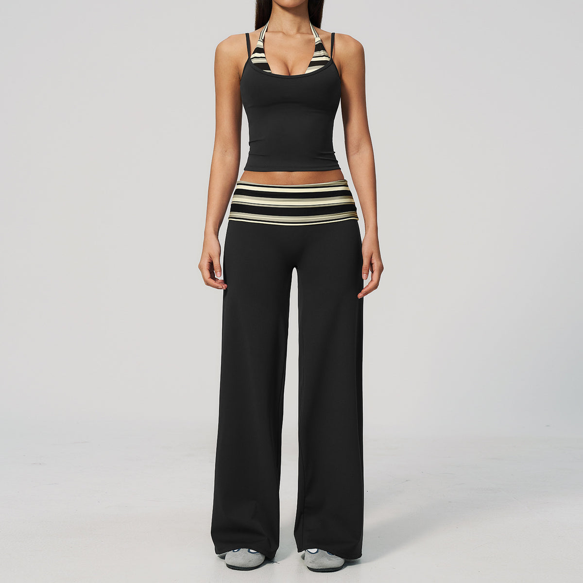 Model in a cropped camisole and wide leg fold over waist pants set, black with cream stripes