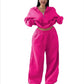 Hot pink cropped half-zip sweatshirt and wide-leg sweatpants set on a model, size M option