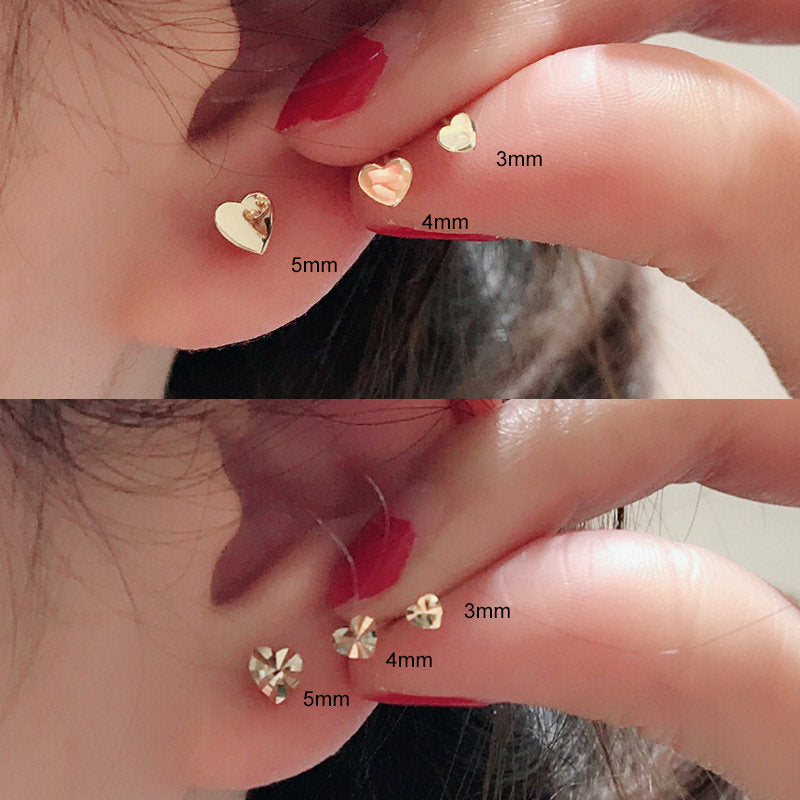 Mini heart gold stud earring side profile showing the post and heart shape close up