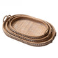 Set of three oval rattan trays nested together with studded wooden rims and arched handles, Three-piece set option
