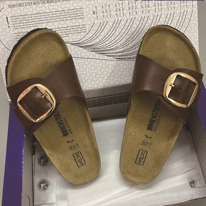 Open toe flat sandal showing gold buckle strap detail