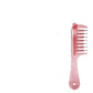 Pink transparent hair comb with ball tipped teeth and a heart shaped hole in the handle on white background