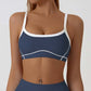 Close view of the contrast piping tracing the bust seams of the strappy sports bra