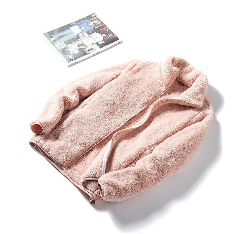 Soft pink plush fleece zip jacket laid open to reveal the deep plush pile on both faces