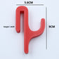 Red resin single hook with size marks, 5.6 cm wide and 9 cm tall, seen from the front on a light background