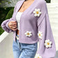 Front view of the floral lantern sleeve knit cardigan worn open on a model