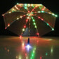 Front view of a clear LED umbrella at night with multicolor LED dots along every rib and a lit handle tip
