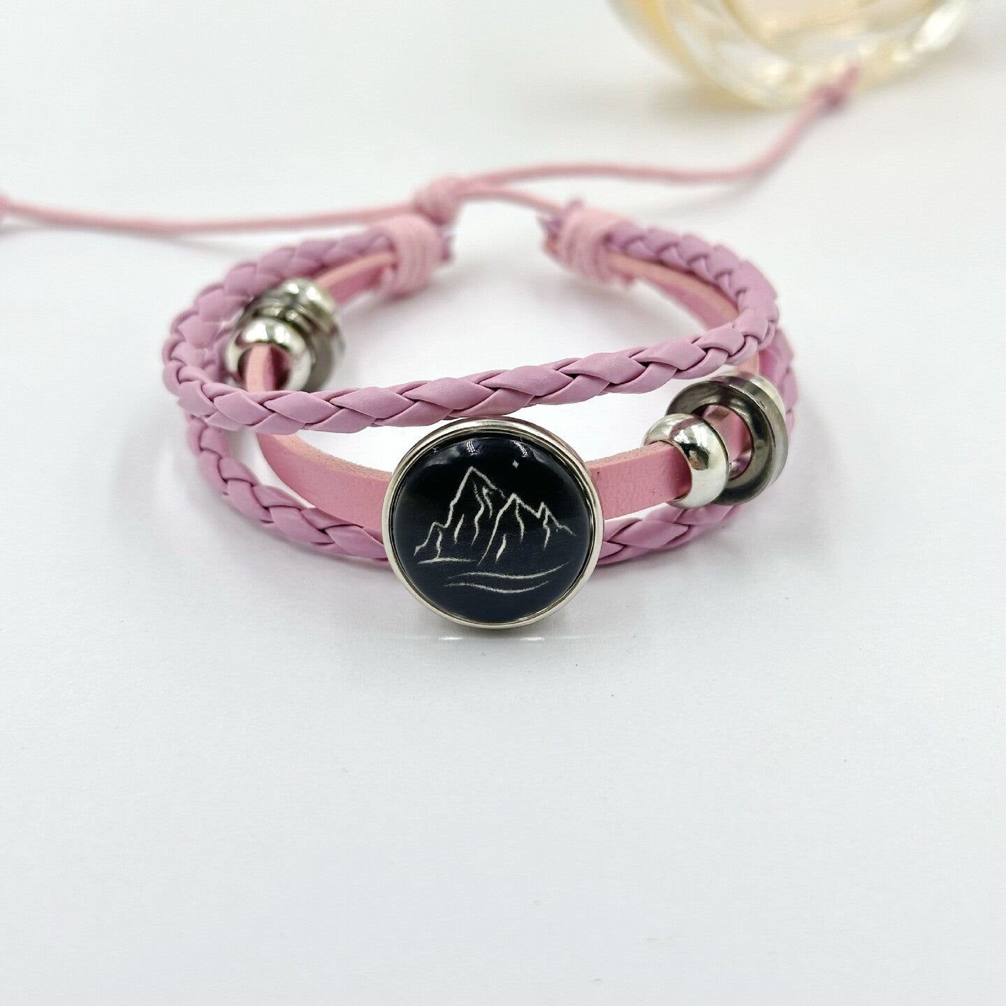 Braided cord charm bracelet shown from above with the sliding knot at the back