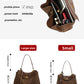 Suede leather tote bag held by the handles showing roomy main compartment