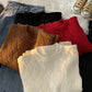Heavyweight round neck knit pullover with a raised basketweave jacquard texture laid flat