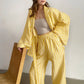 Side view of the tie-up top showing the knot at the waist and high-waisted trousers