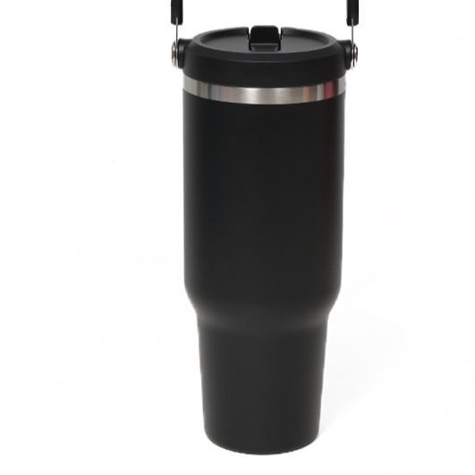 Black insulated tumbler with a stainless steel ring below the flip lid and a handle at the top