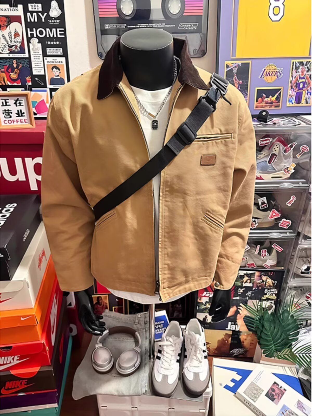 Khaki zip-up jacket with brown collar worn with a black crossbody bag, front view with chest pocket