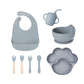 Dark blue gray 8-piece baby feeding set with a bib, a sippy cup, a bowl, four utensils and a bear paw plate