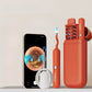 Orange red Bebird ear cleaner wand with fine tweezer tip and phone showing the live ear canal view