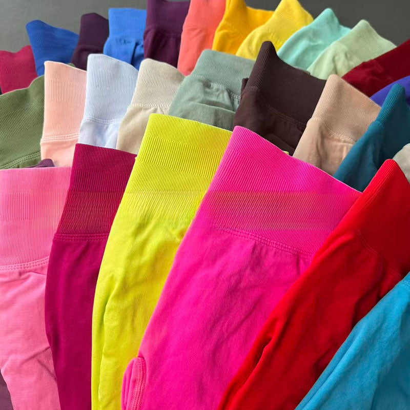 Close flat lay of several colourways showing the tall ribbed waistband on each pair