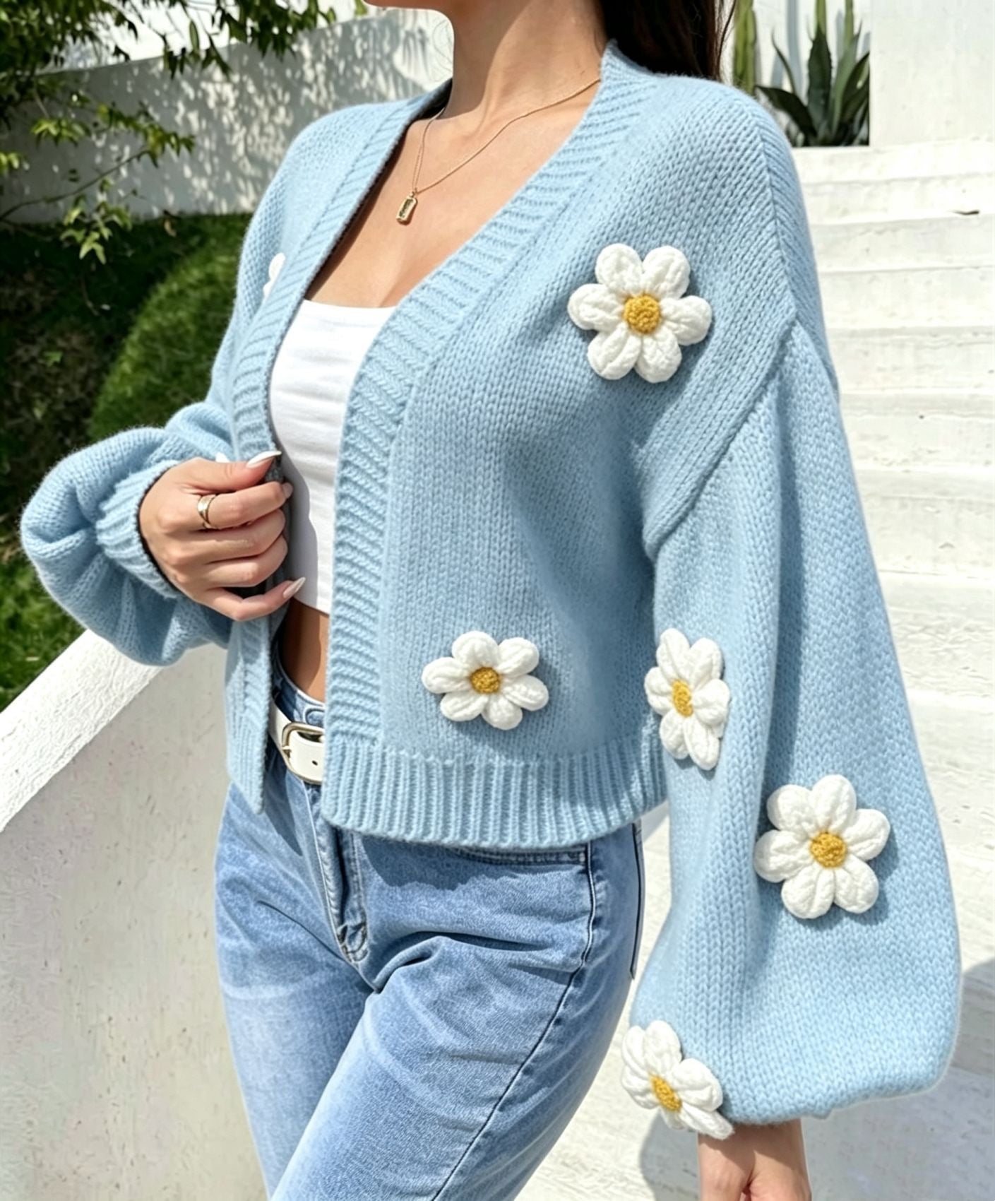 Back view of the open front floral knit cardigan showing the relaxed cut
