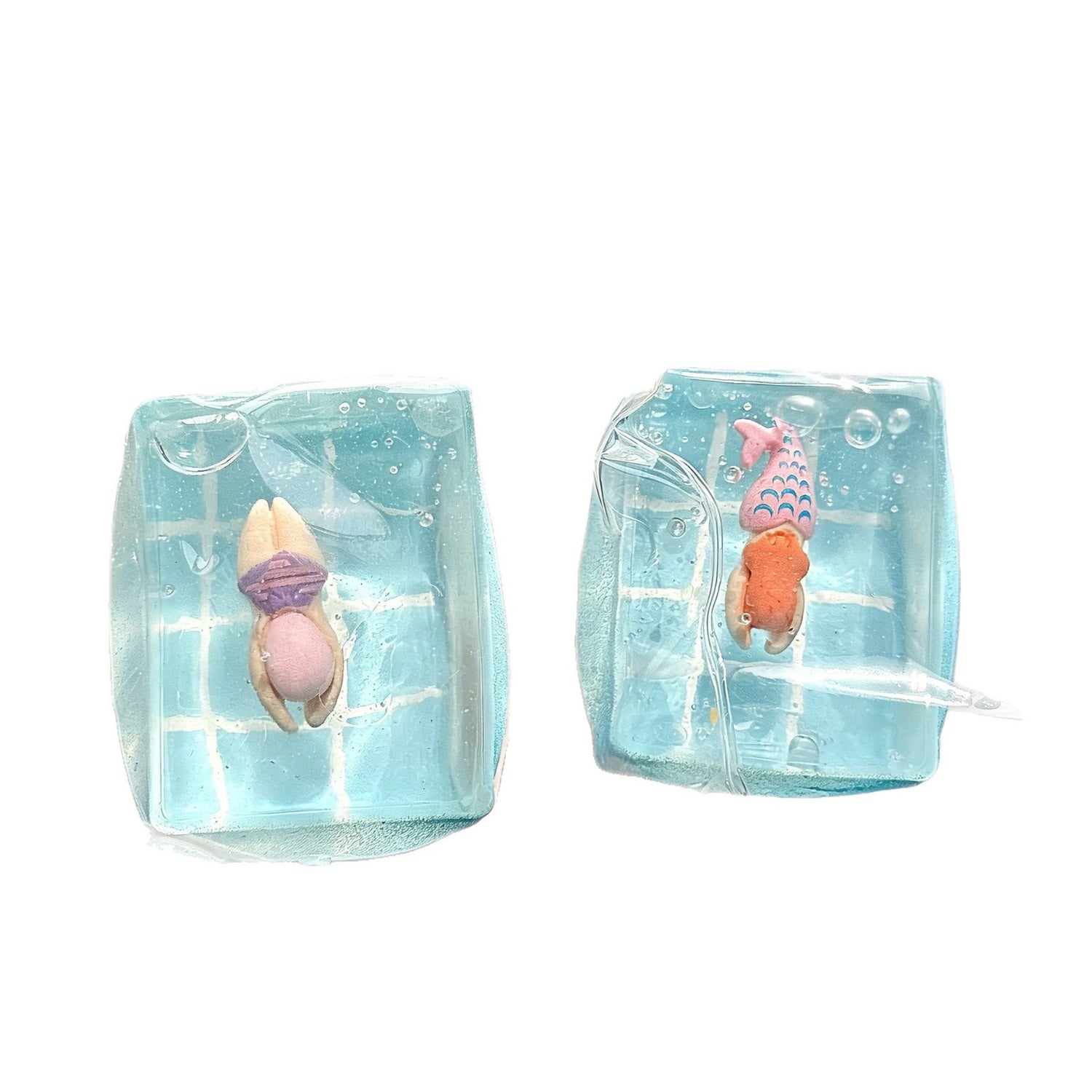 Hand squeezing a soft clear TPR ocean squishy sensory toy block