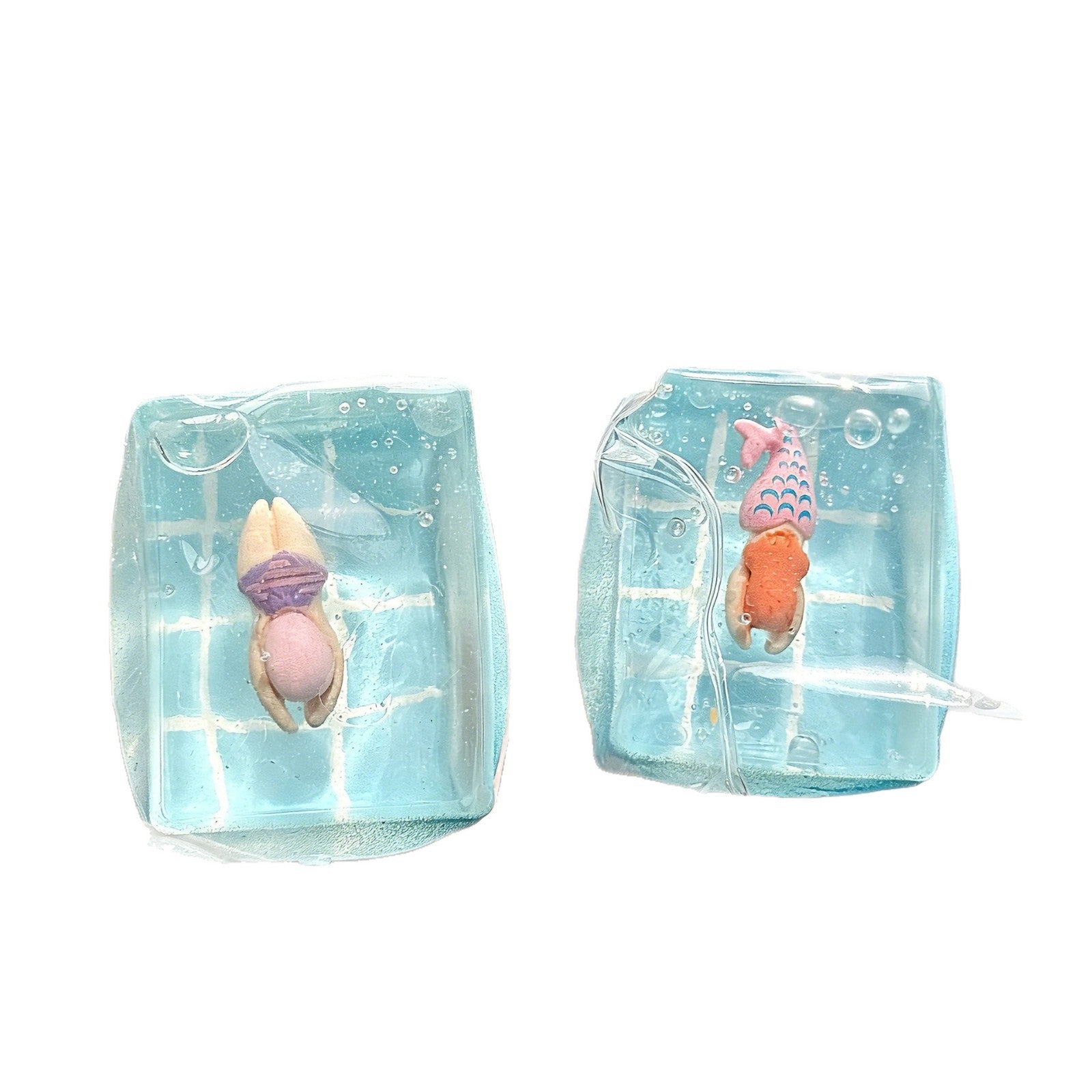 Hand squeezing a soft clear TPR ocean squishy sensory toy block