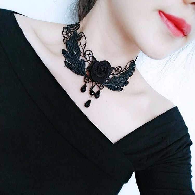 Vintage lace choker necklace displayed on a neck form against a plain backdrop