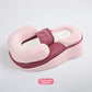 Pink baby positioning lounger with a raised head cradle, side bolsters, mesh panel and body strap